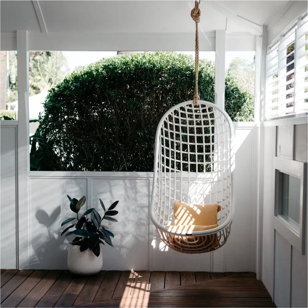 Finished outdoor space with a hanging chair